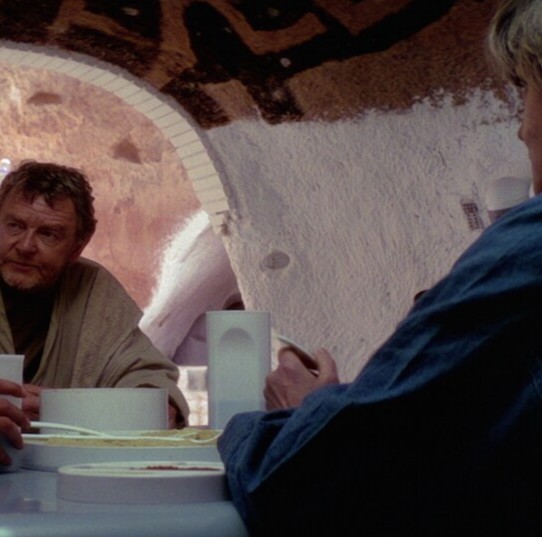 A man and a woman sitting at a table in their home
