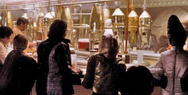 Interior of spaceport cantina with patrons standing around
