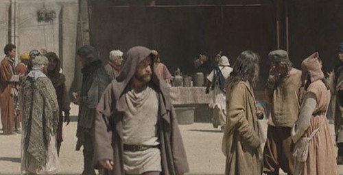 A variety of people walking through the streets of Mon Eisley